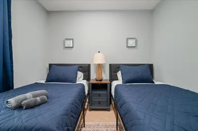 two beds sitting next to each other in a room at 6 bdr Yonkers Home 2 Apts Balcony & Parking in Yonkers
