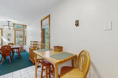 a kitchen and dining room with a table and chairs at Haystack 32 in Wilmington