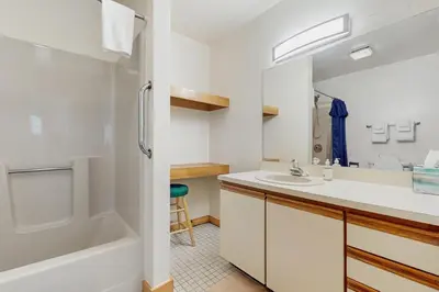a bathroom with a tub and a sink and a shower at Haystack 32 in Wilmington