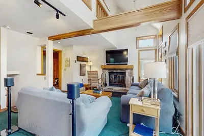 a living room with a couch and a fireplace at Haystack 32 in Wilmington