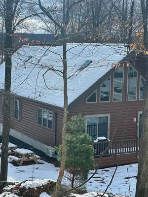 a house with a snow covered roof at Luxury Cabin with Outdoor HotTub-NEW Construction in Lake Ariel