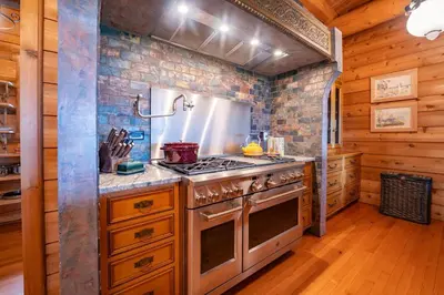 a kitchen with a stove and a stone wall at Welcome to the Lodge! Little Falls NY in Little Falls