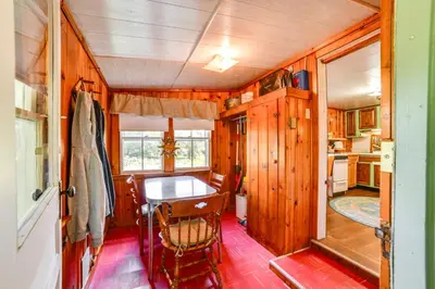 a dining room and kitchen with a table and chairs at 25 Mi to Elk Mtn Skiing! Susquehanna River Cabin
