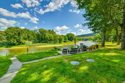 a view of a river with picnic tables and chairs at 25 Mi to Elk Mtn Skiing! Susquehanna River Cabin