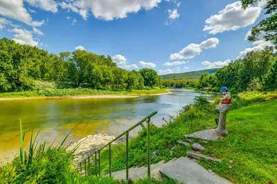 a person is standing next to a river at 25 Mi to Elk Mtn Skiing! Susquehanna River Cabin