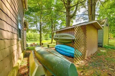 a group of boats are parked next to a house at 25 Mi to Elk Mtn Skiing! Susquehanna River Cabin