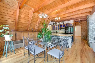 a kitchen and dining room with a table and chairs at A-Frame Retreat Next to Grafton Lakes St Park