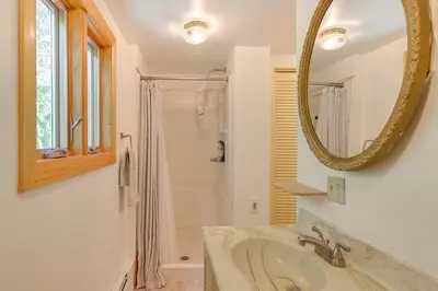a bathroom with a sink and a mirror at A-Frame Retreat Next to Grafton Lakes St Park