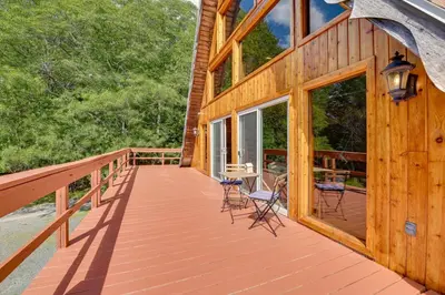 a large wooden deck with chairs and tables on it at A-Frame Retreat Next to Grafton Lakes St Park