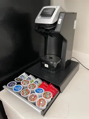 a coffee maker with cupcakes on a shelf with a tray of food at RARE 1BR Apt with Character GREAT Location! in Albany