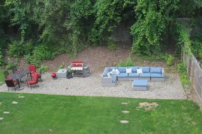 a backyard with a couch and chairs and a table at RARE 1BR Apt with Character GREAT Location! in Albany