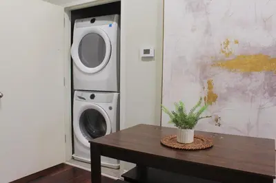 a laundry room with a washing machine and a table at RARE 1BR Apt with Character GREAT Location! in Albany