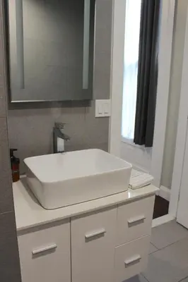 a bathroom with a white sink and a mirror at RARE 1BR Apt with Character GREAT Location! in Albany