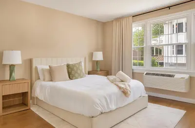 a white bedroom with a large bed and a window at Westville Nest parking NearYale Newly Renovated in New Haven