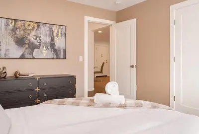 a bedroom with a bed with a large painting on the wall at Westville Nest parking NearYale Newly Renovated in New Haven