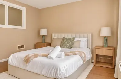 a bedroom with a large white bed with two lamps at Westville Nest parking NearYale Newly Renovated in New Haven
