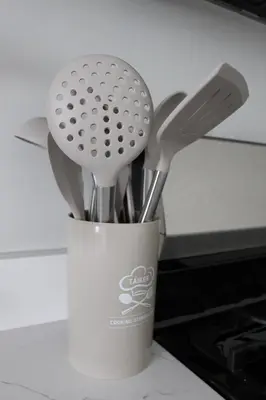 a cup with some utensils in it on a counter at CHIC, Renovated Brownstone in PRIME DT Albany in Albany