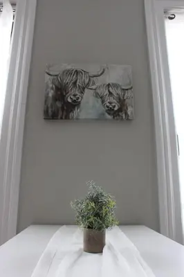 a potted plant sitting on a table with a painting at CHIC, Renovated Brownstone in PRIME DT Albany in Albany