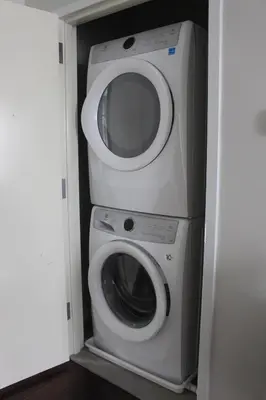 a washer and dryer in a small room at CHIC, Renovated Brownstone in PRIME DT Albany in Albany