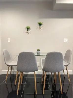 three chairs and a table with plants on a wall at MODERN 1BR Apt with PRIVATE deck in Albany