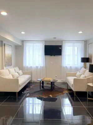 a living room with two white couches and a table at MODERN 1BR Apt with PRIVATE deck in Albany