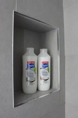 two bottles of bleach in a shelf in a wall at MODERN 1BR GREAT Location Downtown Parking in Albany