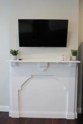 a flat screen tv sitting on top of a white wall at MODERN 1BR GREAT Location Downtown Parking in Albany