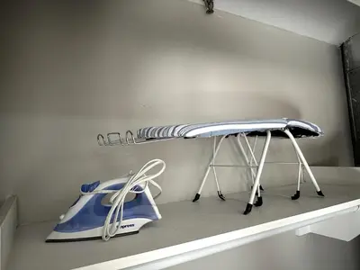 a room with a shelf with a iron and a kettle at Private Entrance Cozy Apt Bright Modern in Albany
