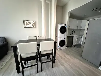 a kitchen with a table and chairs in a room at Private Entrance Cozy Apt Bright Modern in Albany
