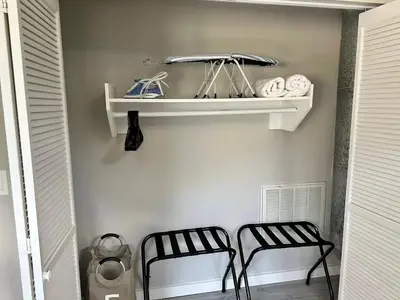 two black chairs sitting next to a shelf with towels at Private Entrance Cozy Apt Bright Modern in Albany