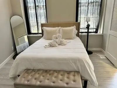 a bedroom with a large bed with a towel on it at Private Entrance Cozy Apt Bright Modern in Albany