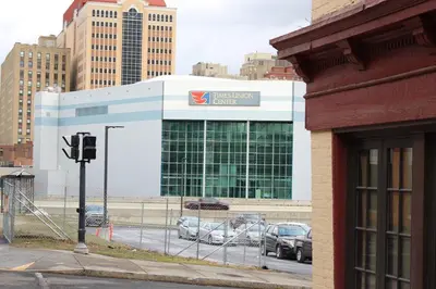 a building with cars parked in a parking lot at 2 BEDROOM 1 BATH TRENDY Apt Downtown Albany in Albany