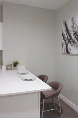 a kitchen with a white counter and two chairs at Beautiful 2 BED 2 BATH Soaker Tub in Albany