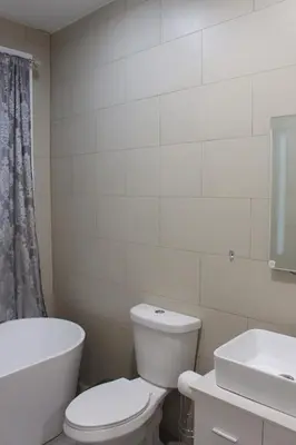 a bathroom with a toilet and a tub and a sink at Beautiful 2 BED 2 BATH Soaker Tub in Albany
