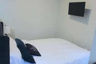 a bedroom with a white bed with two pillows on it at UNIQUE Gem in HEART of Albany Spiral Staircase in Albany