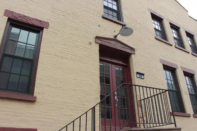 a brick building with a red door and windows at UNIQUE Gem in HEART of Albany Spiral Staircase in Albany
