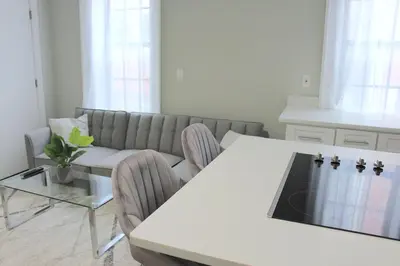 a living room with a white table and a couch at WOW Bright Apt PRIME downtown Walk Everywhere in Albany