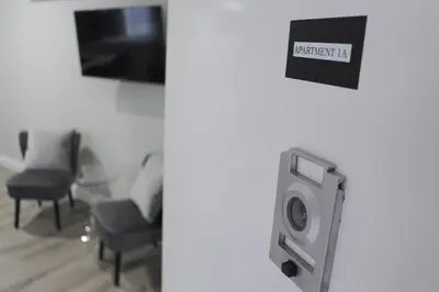 a room with a tv and a chair and a speaker at WOW Bright Apt PRIME downtown Walk Everywhere in Albany