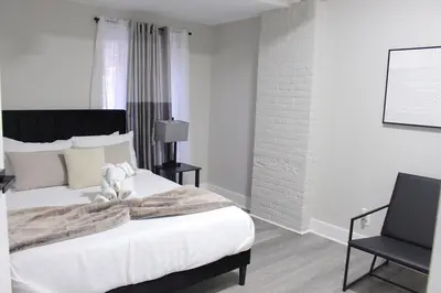 a bedroom with a bed with a teddy bear on it at 2 bdrm Modern & Hip Apt with Private Patio in Albany