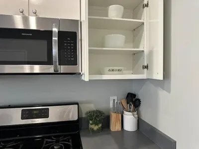 a kitchen with a microwave above a stove at Bright & Airy 1 BDRM Private Apt in Albany