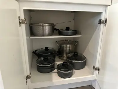 a shelf with pots and pans in a kitchen at Bright & Airy 1 BDRM Private Apt in Albany