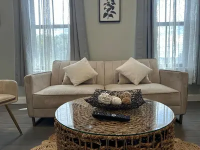 a living room with a couch and a coffee table at Bright & Airy 1 BDRM Private Apt in Albany