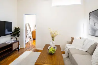 a living room with a couch and a table at Cozy 1BD Upper East Side Gem in New York