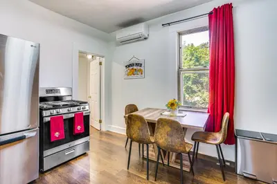 a kitchen with a table and a stove and a window at Walkable Location Pet-Friendly Apartment in Lodi! in Lodi