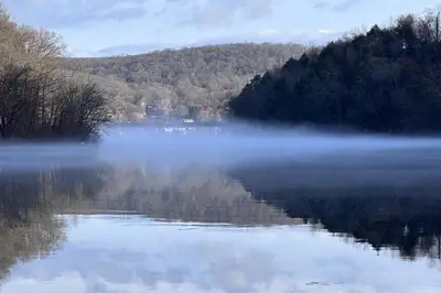 a body of water with fog on the water at Lake Zoar Cabin in Newtown