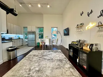 a kitchen and living room with a table and chairs at BP STAYS - Hotel-Style, No Host, Professionally Managed ID302 in Jersey City