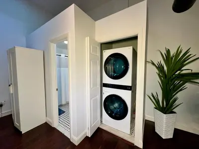 a hallway with two mirrors and a potted plant at BP STAYS - Hotel-Style, No Host, Professionally Managed ID302 in Jersey City