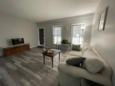 a living room with a couch and a table at Private Apartment in Southbury 104 in Southbury