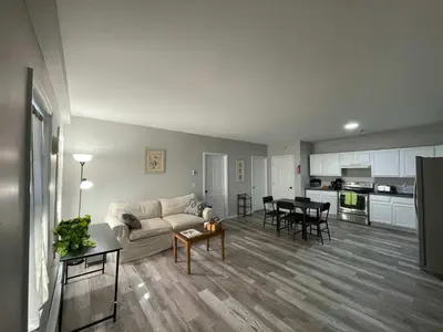 a living room with a couch and a table at Private Apartment in Southbury 104 in Southbury