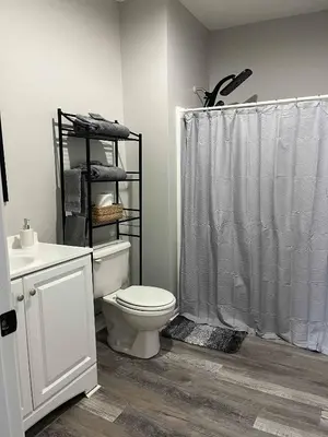 a bathroom with a white toilet and a shower at Private Apartment in Southbury 104 in Southbury